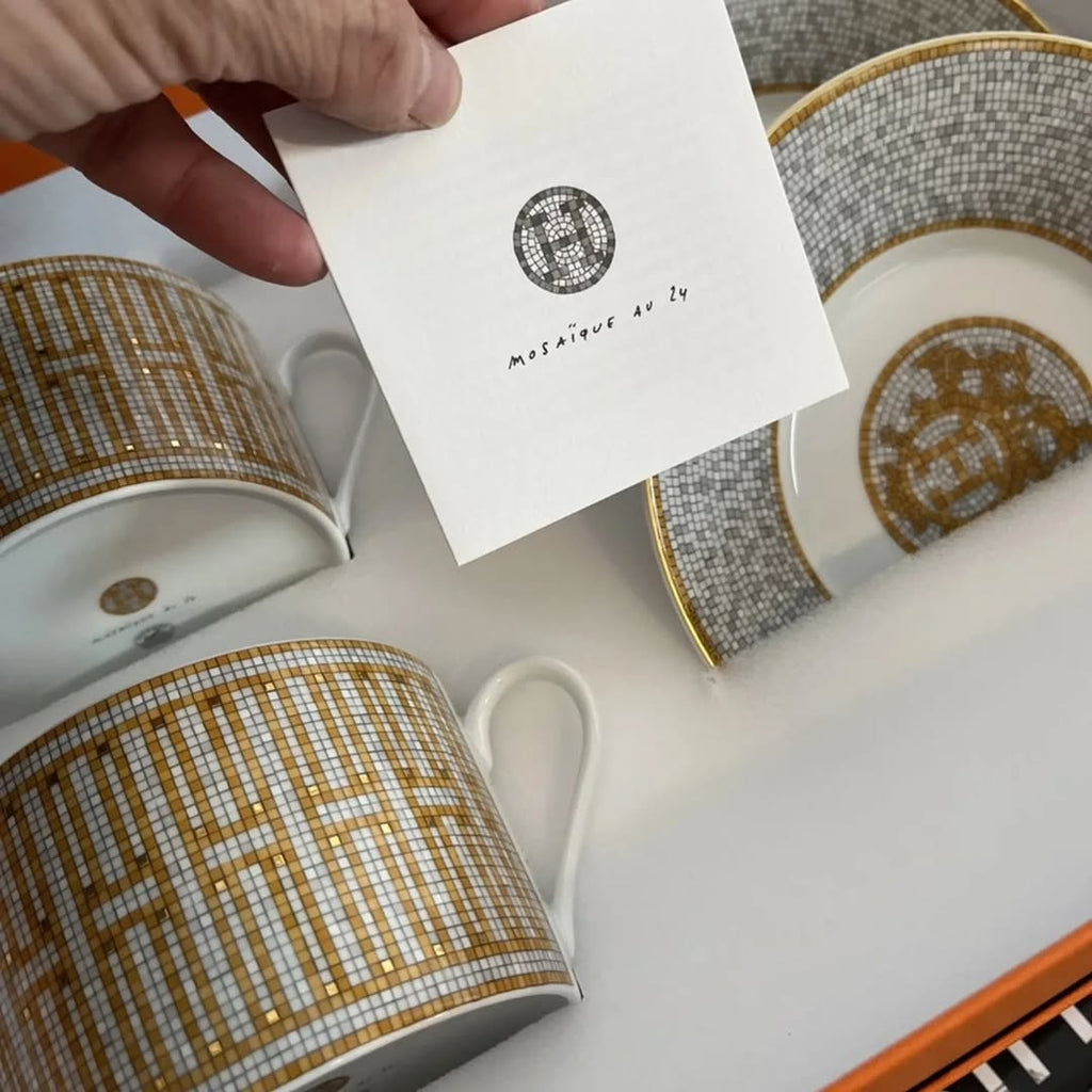 The Hermes Mosaique au 24 gold breakfast cup and saucer set of 2 features a luxurious and elegant design by the renowned brand, HERMES.