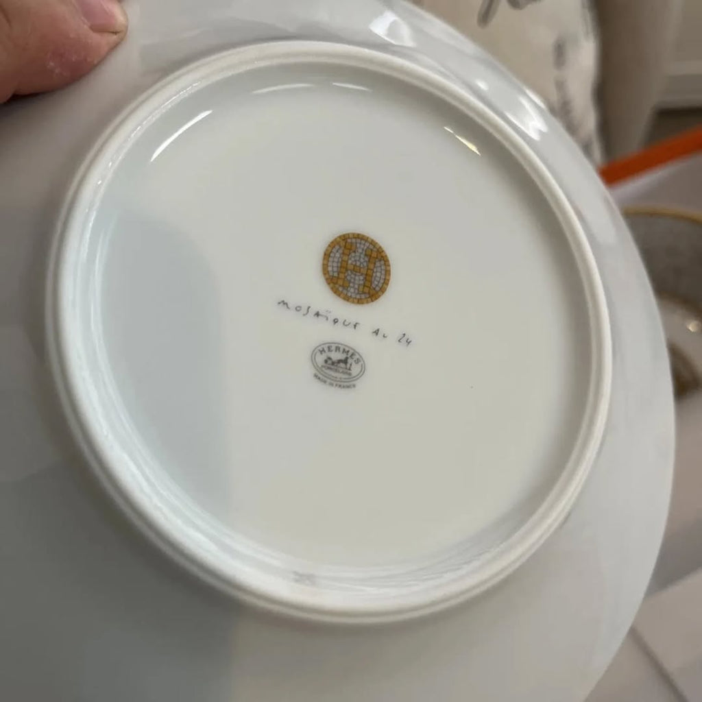 The Hermes Mosaique au 24 gold breakfast cup and saucer set of 2 features a luxurious and elegant design by the renowned brand, HERMES.