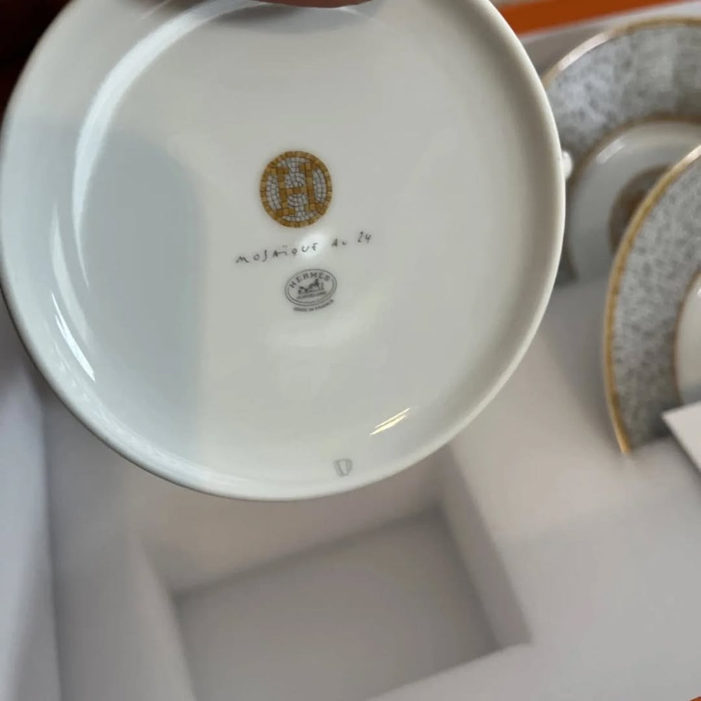 The Hermes Mosaique au 24 gold breakfast cup and saucer set of 2 features a luxurious and elegant design by the renowned brand, HERMES.