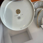 The Hermes Mosaique au 24 gold breakfast cup and saucer set of 2 features a luxurious and elegant design by the renowned brand, HERMES.