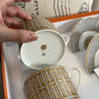 The Hermes Mosaique au 24 gold breakfast cup and saucer set of 2 features a luxurious and elegant design by the renowned brand, HERMES.