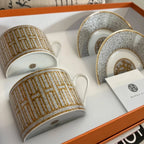 The Hermes Mosaique au 24 gold breakfast cup and saucer set of 2 features a luxurious and elegant design by the renowned brand, HERMES.