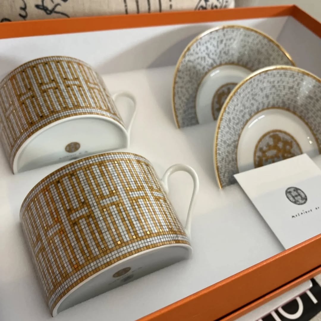 The Hermes Mosaique au 24 gold breakfast cup and saucer set of 2 features a luxurious and elegant design by the renowned brand, HERMES.